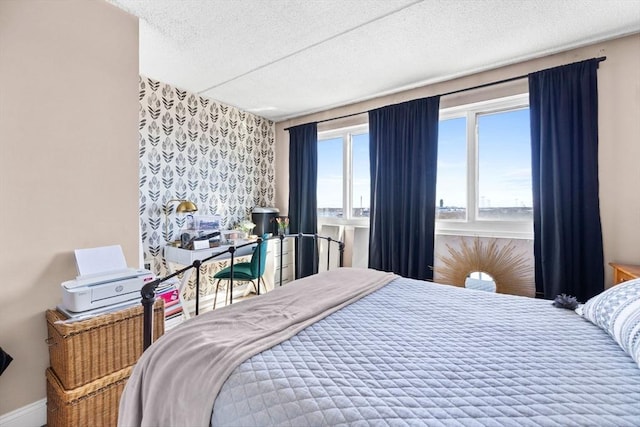 bedroom featuring a textured ceiling and baseboards