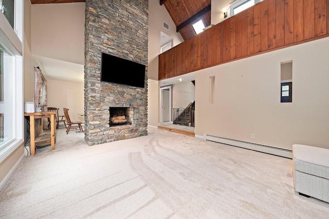 28-R Pammys Path, Easton, MA 02356 - unfurnished living room with a baseboard heating unit, high vaulted ceiling, stairway, carpet floors, and a stone fireplace