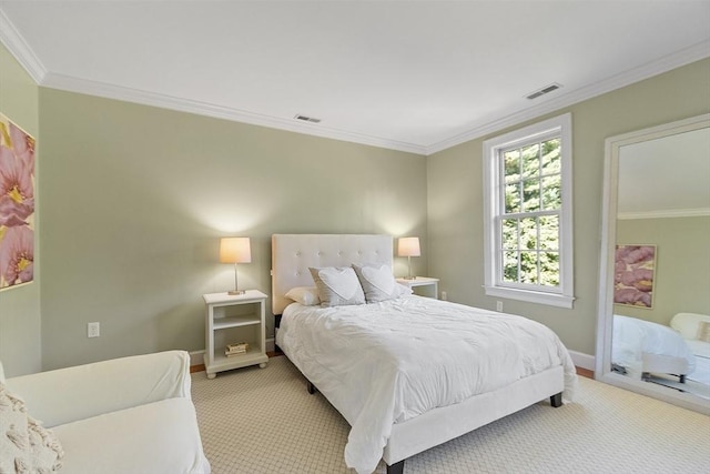 bedroom with light carpet, visible vents, and crown molding