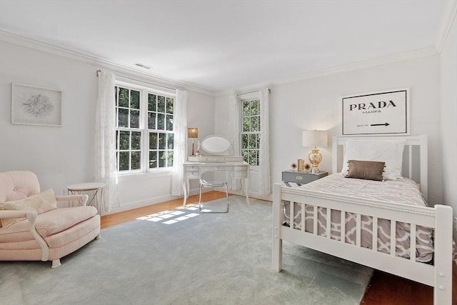 bedroom with visible vents, crown molding, and baseboards