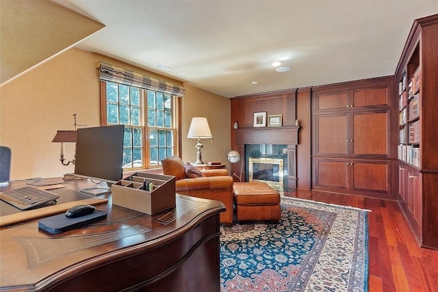 office area featuring dark wood-style flooring and a high end fireplace