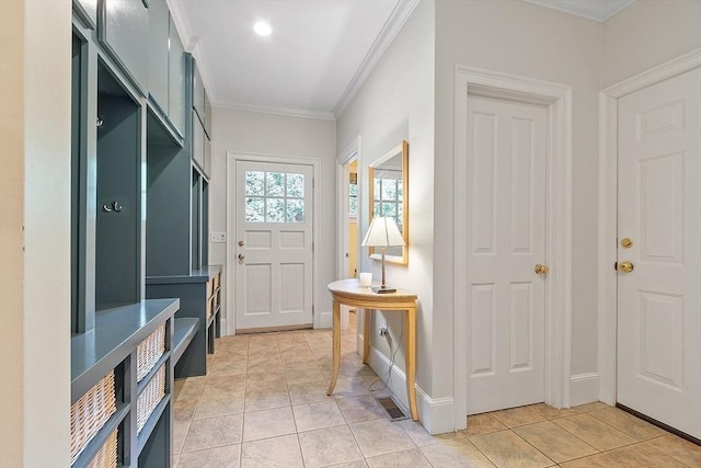 mudroom with crown molding, light tile patterned floors, and baseboards