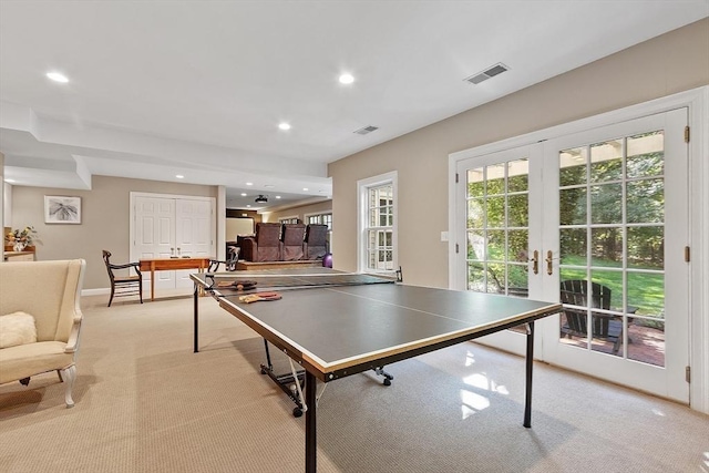 recreation room featuring recessed lighting, french doors, light colored carpet, and visible vents