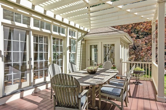 wooden terrace featuring french doors, outdoor dining space, and a pergola