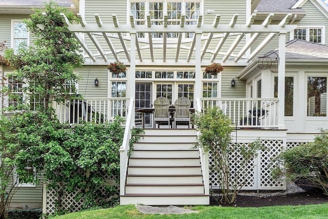 doorway to property featuring a pergola and a shingled roof