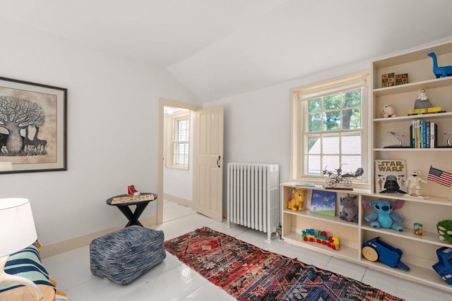 120 Court St, Dedham, MA 02026 - living area featuring radiator, vaulted ceiling, and tile patterned flooring
