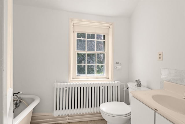 120 Court St, Dedham, MA 02026 - bathroom with radiator heating unit, a freestanding tub, healthy amount of natural light, and toilet