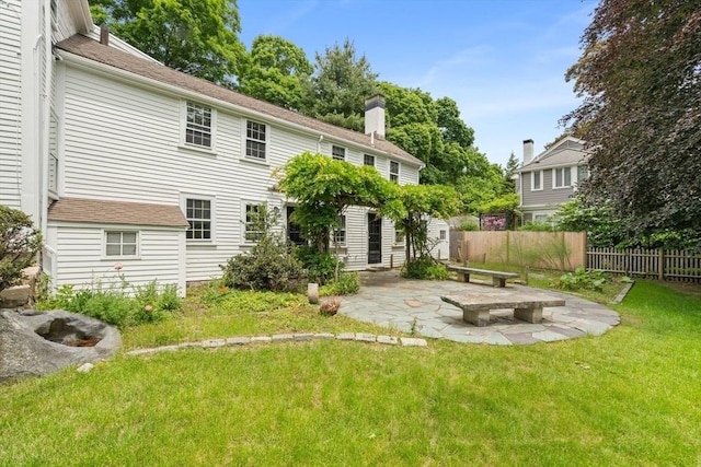120 Court St, Dedham, MA 02026 - rear view of property with a patio and a chimney