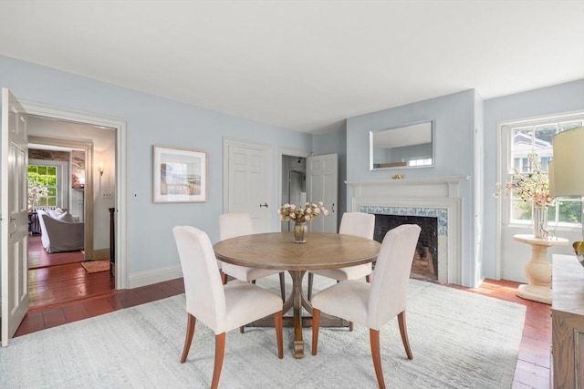 120 Court St, Dedham, MA 02026 - dining room with light wood-style flooring, a high end fireplace, and baseboards