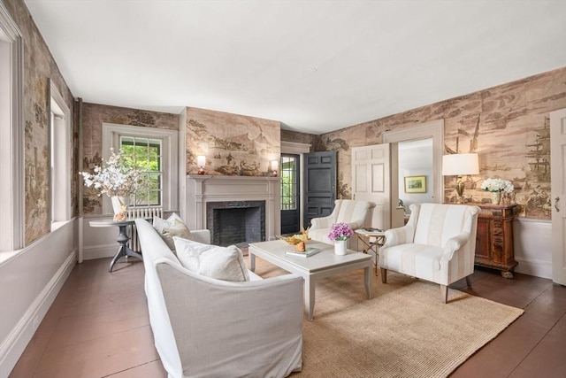 120 Court St, Dedham, MA 02026 - living area with healthy amount of natural light, wallpapered walls, a fireplace, and baseboards