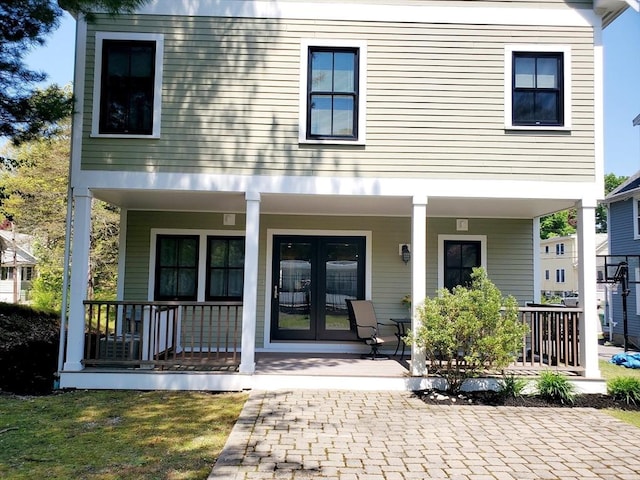 rear view of property with french doors and covered porch