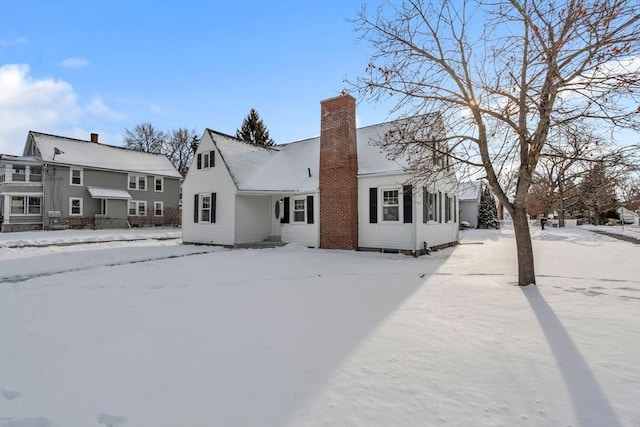 view of snow covered rear of property