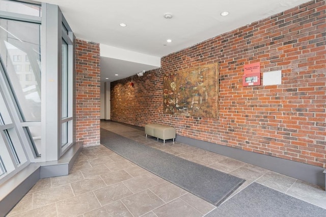 99 Chestnut Hill Ave Unit 212, Boston, MA 02135 - hallway featuring brick wall and recessed lighting
