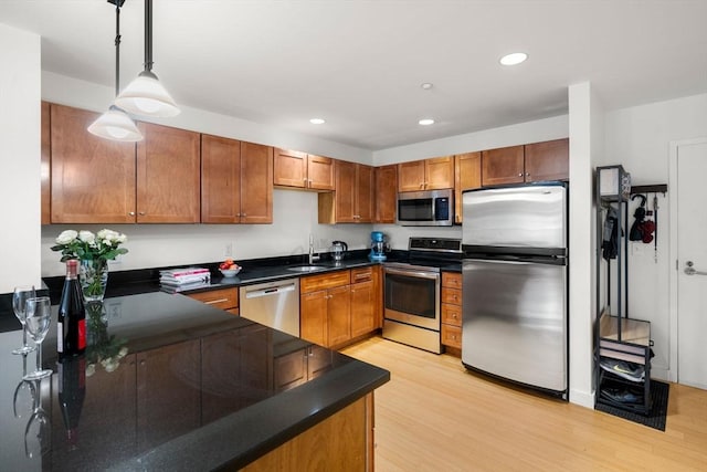 99 Chestnut Hill Ave Unit 212, Boston, MA 02135 - kitchen with stainless steel appliances, a sink, dark countertops, light wood-style flooring, and recessed lighting