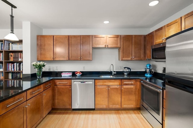 99 Chestnut Hill Ave Unit 212, Boston, MA 02135 - kitchen featuring stainless steel appliances, a sink, light wood-style floors, recessed lighting, and brown cabinets