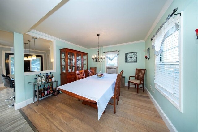 1286 Locust St, Fall River, MA 02723 - dining room featuring light wood-style flooring, a chandelier, ornamental molding, baseboards, and cooling unit