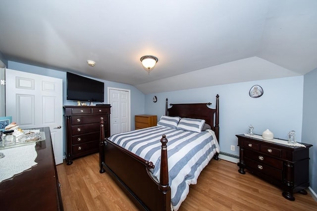 1286 Locust St, Fall River, MA 02723 - bedroom with a baseboard heating unit, vaulted ceiling, light wood-type flooring, and a closet