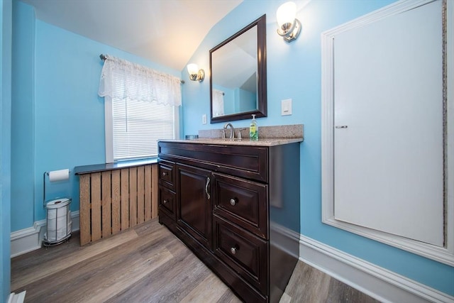 1286 Locust St, Fall River, MA 02723 - bathroom with wood finished floors, vaulted ceiling, and vanity