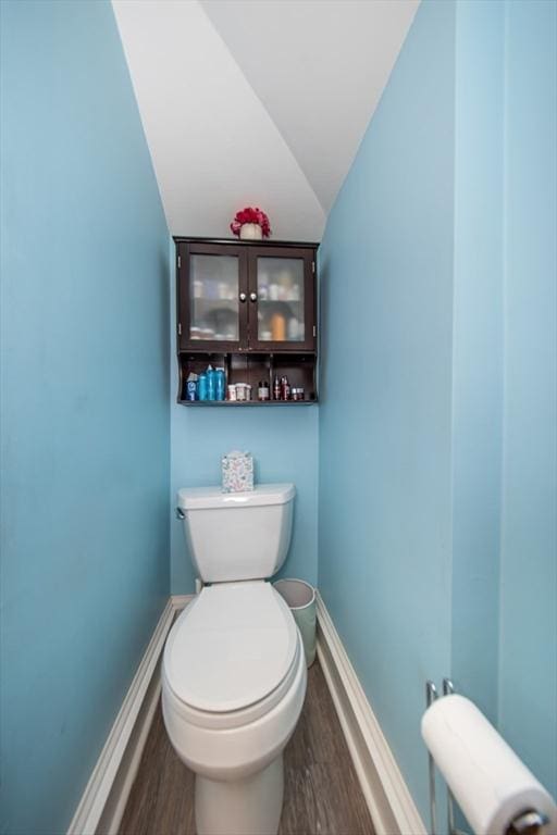 1286 Locust St, Fall River, MA 02723 - bathroom featuring wood finished floors, toilet, vaulted ceiling, and baseboards