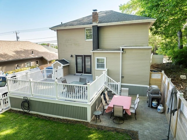 1286 Locust St, Fall River, MA 02723 - back of property with outdoor dining area, a fenced backyard, a wooden deck, a chimney, and a patio