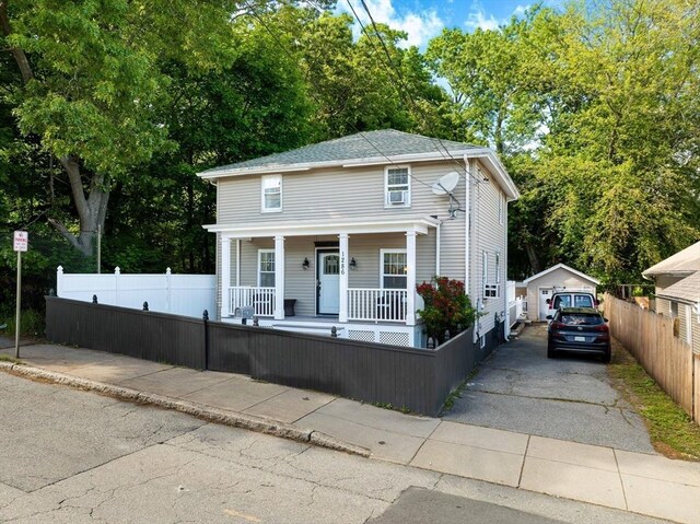 1286 Locust St, Fall River, MA 02723 - view of front of house featuring a porch, a fenced front yard, and a garage