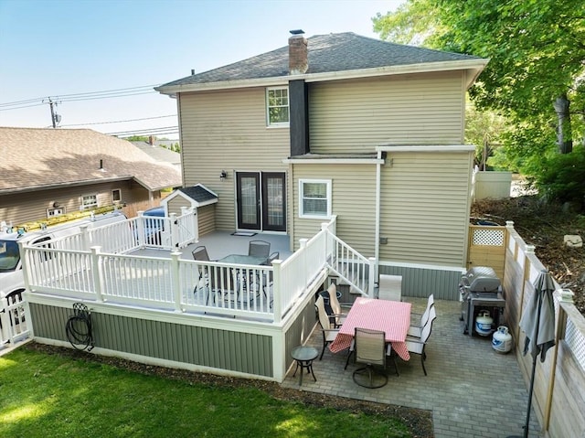 1286 Locust St, Fall River, MA 02723 - back of house featuring outdoor dining space, a fenced backyard, a wooden deck, a chimney, and a patio