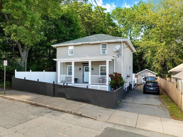 1286 Locust St, Fall River, MA 02723 - view of front of home featuring a porch, a fenced front yard, and a detached garage