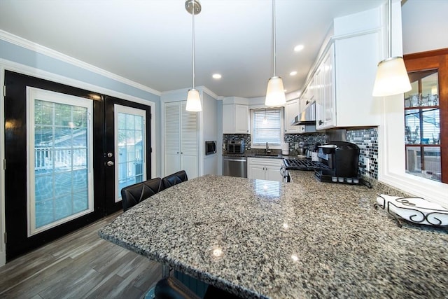 1286 Locust St, Fall River, MA 02723 - kitchen with french doors, a sink, under cabinet range hood, white cabinetry, and ornamental molding