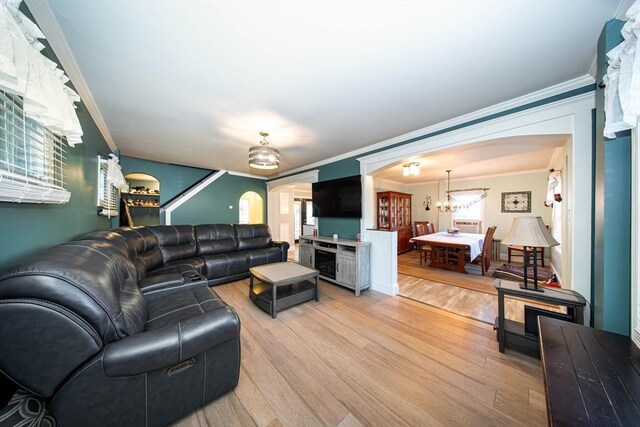 1286 Locust St, Fall River, MA 02723 - living area featuring arched walkways, ornamental molding, and light wood-type flooring