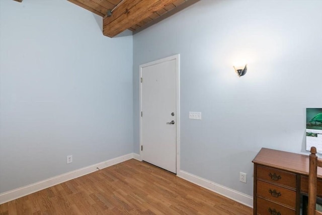 entrance foyer with light wood-style floors, baseboards, beamed ceiling, and wood ceiling