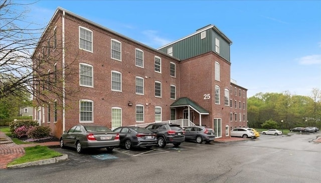 view of building exterior featuring uncovered parking