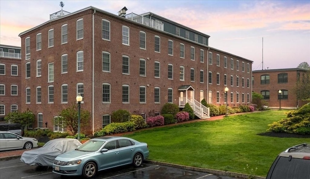 view of building exterior featuring uncovered parking