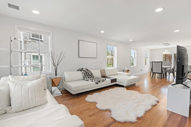 living room with visible vents, recessed lighting, and light wood-type flooring