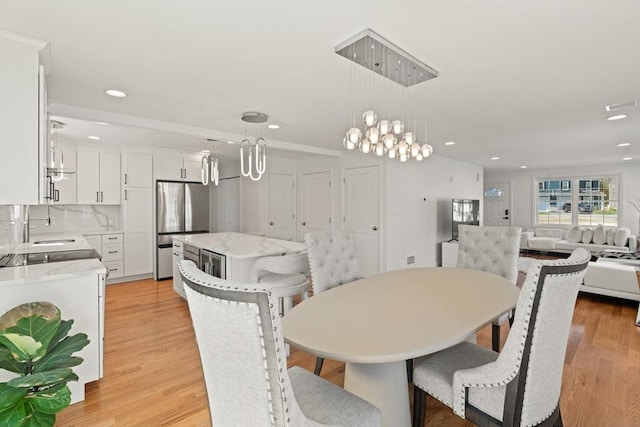 dining area featuring recessed lighting, light wood finished floors, and visible vents