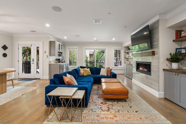 654 E 7th Unit 3, Boston, MA 02127 - living area with wood finished floors, a fireplace, ornamental molding, recessed lighting, and baseboards