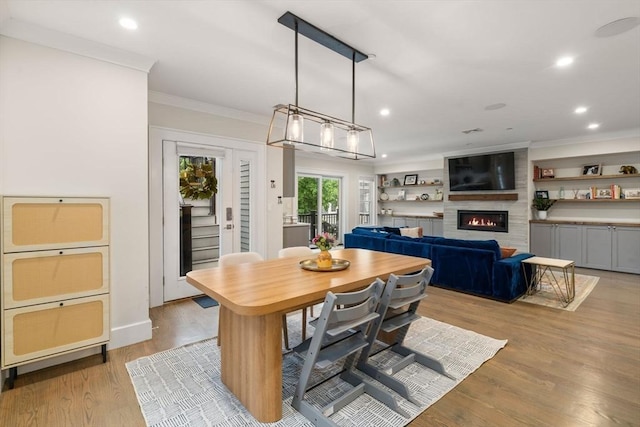 654 E 7th Unit 3, Boston, MA 02127 - dining area with a fireplace, crown molding, light wood-style floors, recessed lighting, and baseboards