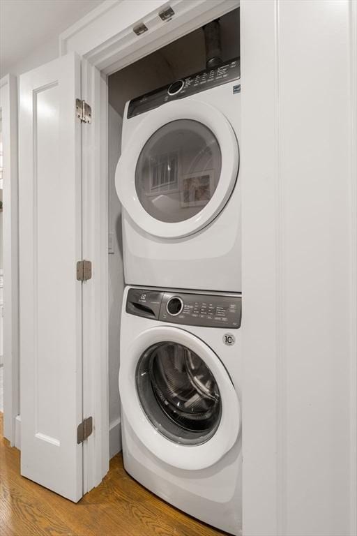 654 E 7th Unit 3, Boston, MA 02127 - washroom with stacked washer and clothes dryer and light wood finished floors