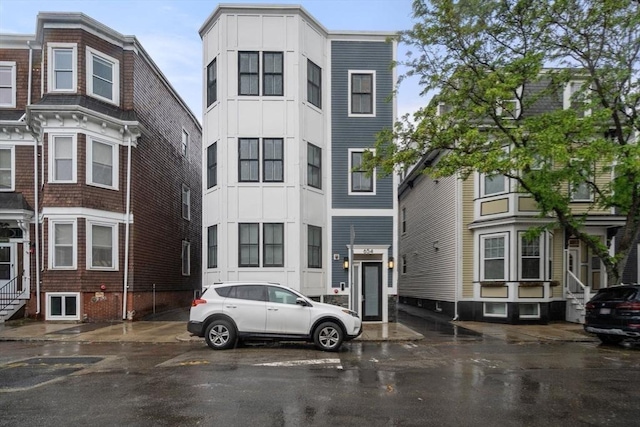 654 E 7th Unit 3, Boston, MA 02127 - view of front facade featuring uncovered parking, entry steps, and board and batten siding
