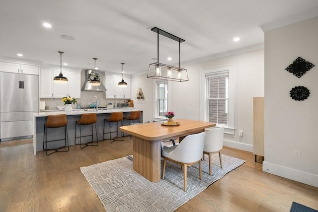 654 E 7th Unit 3, Boston, MA 02127 - dining room featuring light wood finished floors, baseboards, recessed lighting, and crown molding