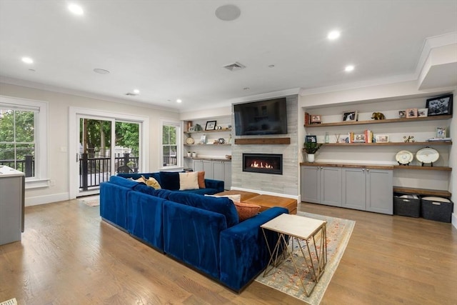 654 E 7th Unit 3, Boston, MA 02127 - living room with ornamental molding, a fireplace, light wood finished floors, recessed lighting, and baseboards