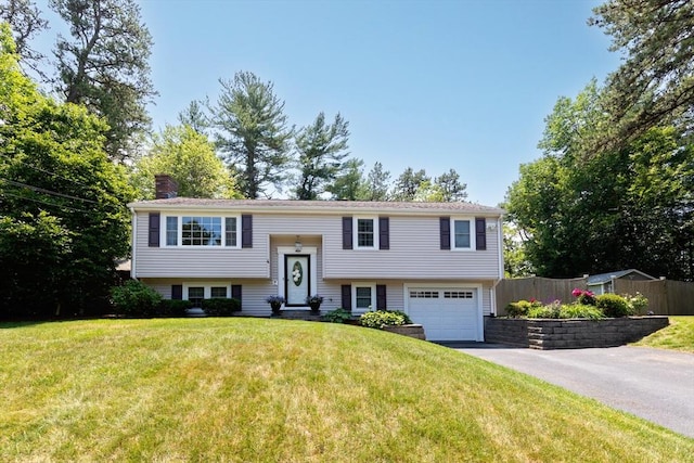 4 Jester Way, Plymouth, MA 02360 - split foyer home with driveway, a chimney, and an attached garage