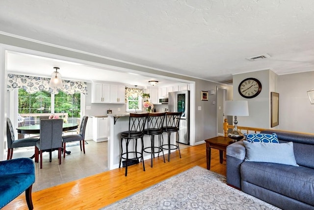 4 Jester Way, Plymouth, MA 02360 - living area featuring healthy amount of natural light, light wood finished floors, and ornamental molding