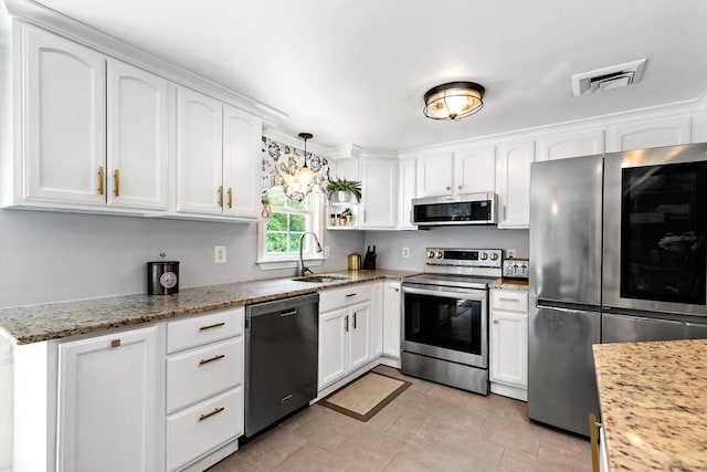 4 Jester Way, Plymouth, MA 02360 - kitchen featuring appliances with stainless steel finishes, white cabinetry, decorative light fixtures, and light stone countertops
