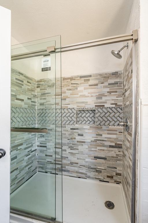bathroom with a shower stall