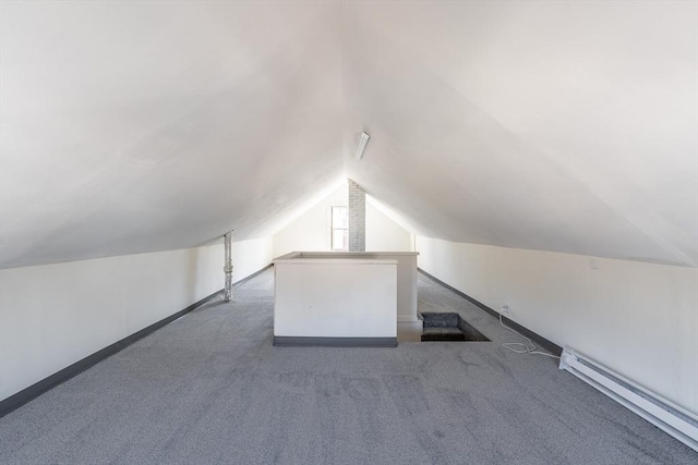 additional living space with carpet floors, a baseboard heating unit, baseboards, and lofted ceiling