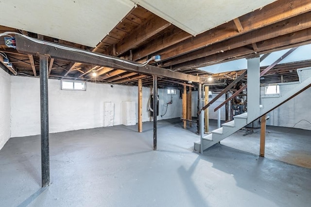 below grade area featuring stairway and a healthy amount of sunlight