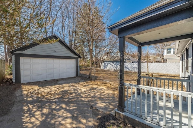 detached garage featuring fence