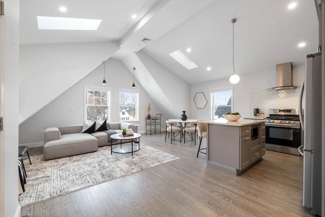 living room with light wood-type flooring and lofted ceiling with skylight