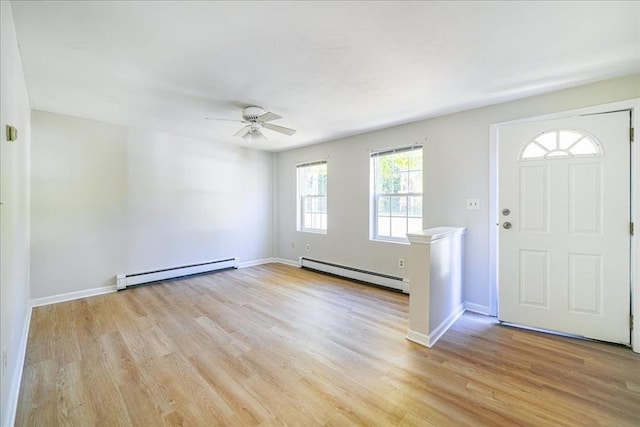 foyer entrance with a baseboard radiator, a ceiling fan, baseboards, baseboard heating, and light wood-type flooring