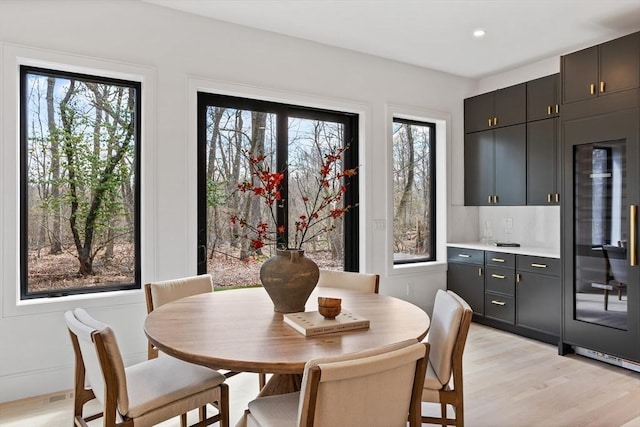48 Sherburne Rd, Lexington, MA 02421 - dining area with bar with sink, light wood finished floors, and recessed lighting